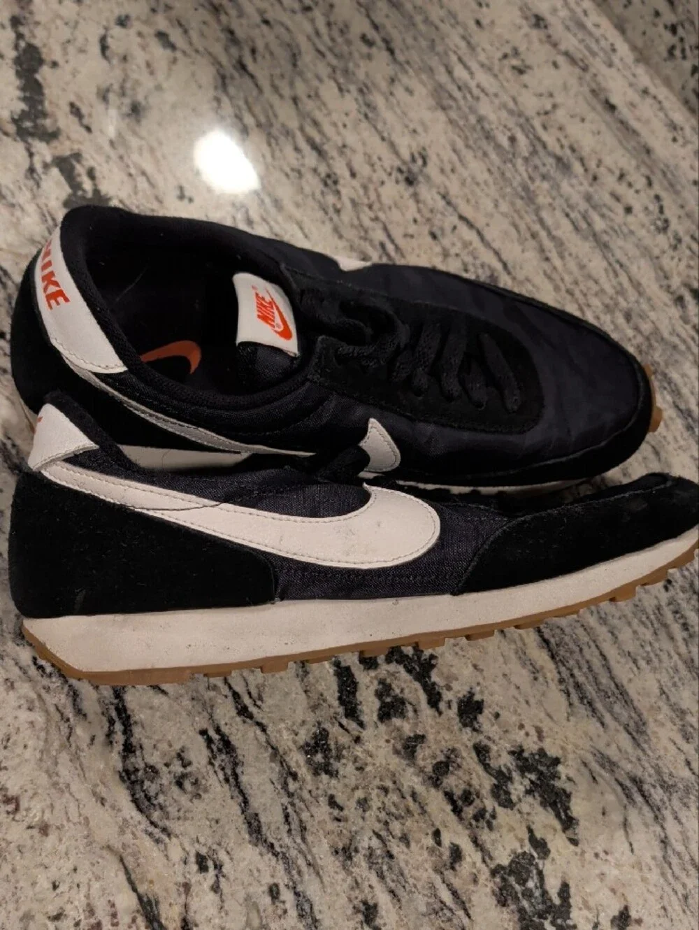 Nike Black Sneakers with White Swoosh and Orange Tongue Logo